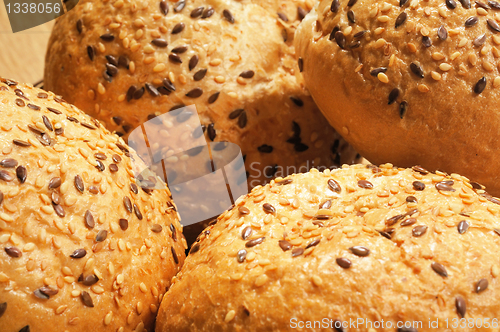 Image of Bun, topped with sesame seeds in a basket