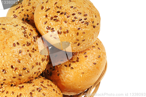 Image of Bun, topped with sesame seeds in a basket