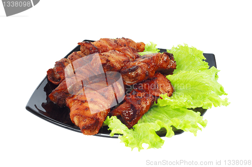 Image of Roasted meat, wrapped in bacon on the dish