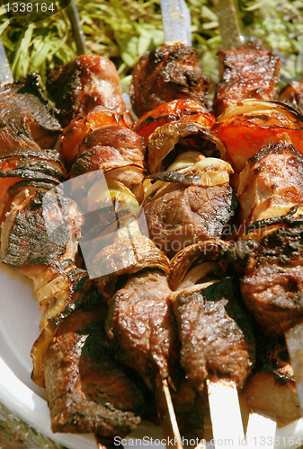 Image of Grilled meat on a skewer. Close up