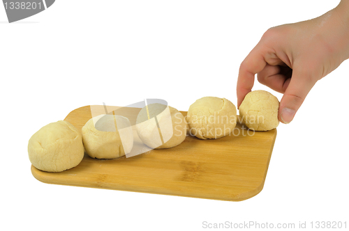 Image of Flour the dough on a wooden board