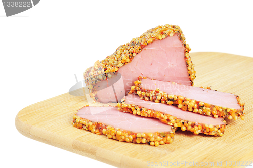 Image of Piece of a ham with spices on a wooden board