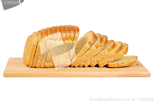 Image of Sliced bread on wooden board.