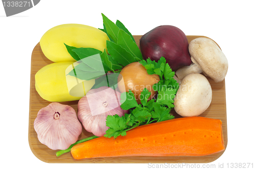 Image of Board with potatoes, garlic, carrots, mushrooms