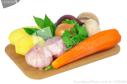 Image of Board with potatoes, garlic, carrots, mushrooms