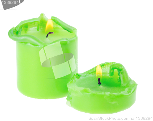 Image of Two large green lighted candle