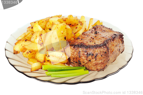 Image of Grilled meat and  fried  potatoes  on a plate
