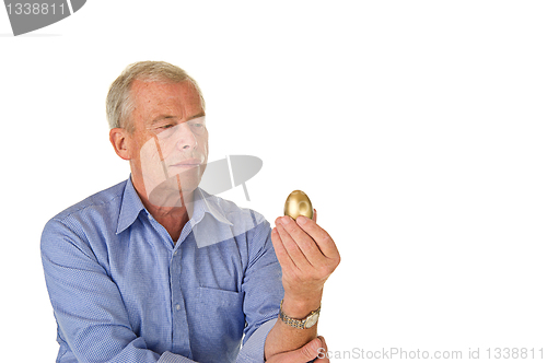 Image of Senior man with golden egg