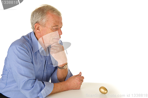 Image of Senior man with golden egg