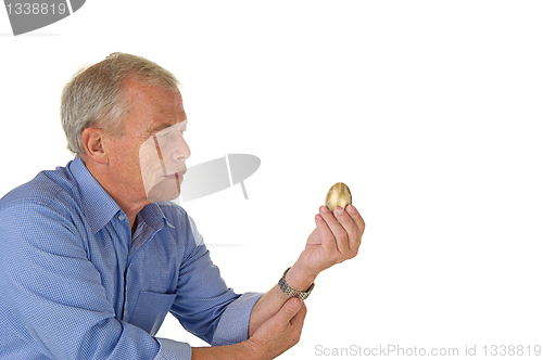 Image of Senior man with golden egg