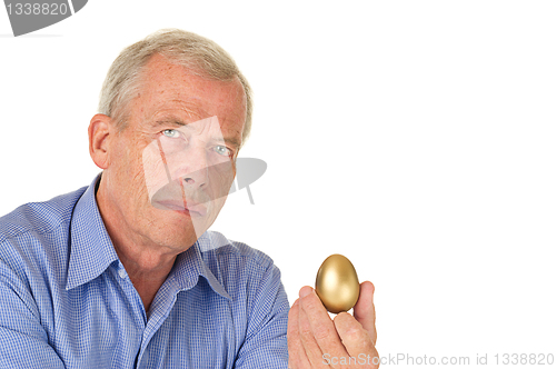 Image of Senior man with golden egg
