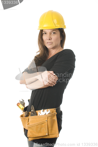 Image of female worker carpenter builder with tool belt and hard hat helm