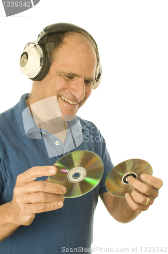 Image of middle age senior man listening to music through classic head ph