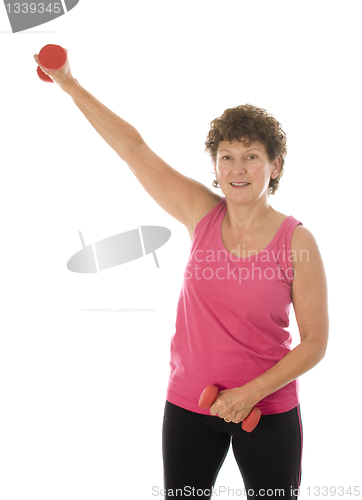 Image of senior middle age woman exercising with dumbbells 