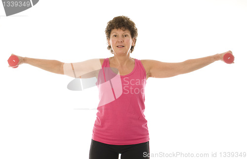 Image of senior middle age woman exercising with dumbbells 