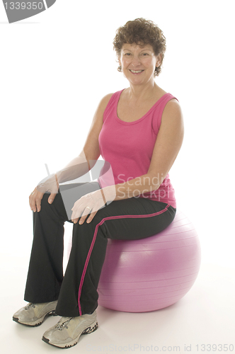Image of woman exercising core training fitness ball