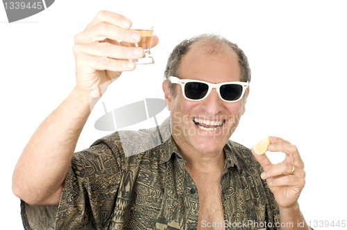 Image of middle age senior tourist male sun glasses  drinking tequila sho