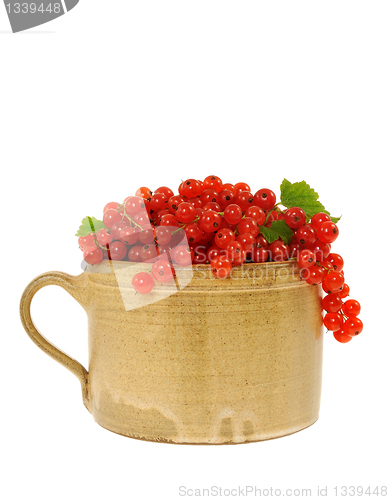 Image of Ceramic cup full of fresh red currant berries. Clipping path included