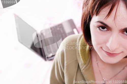 Image of Young woman in bed