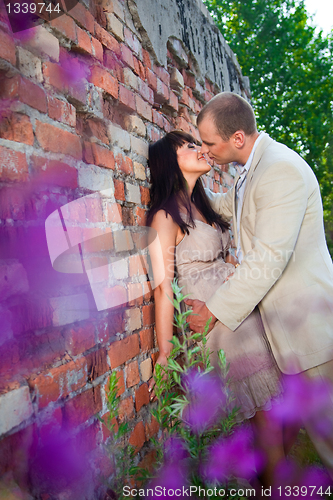 Image of Romantic kiss near old brick wall