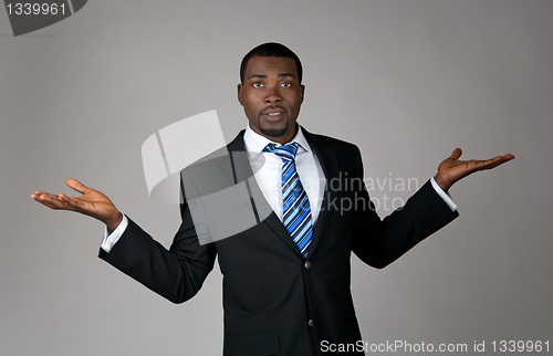Image of African American businessman looking puzzled