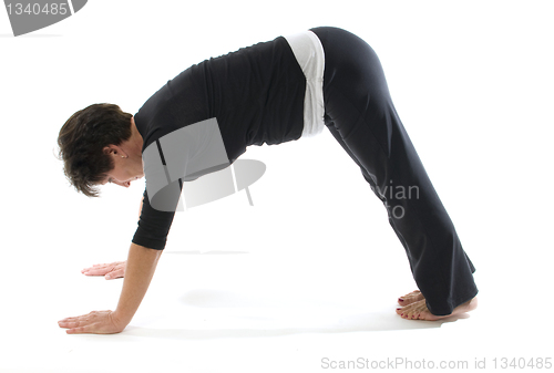 Image of female yoga position downward facing dog pose