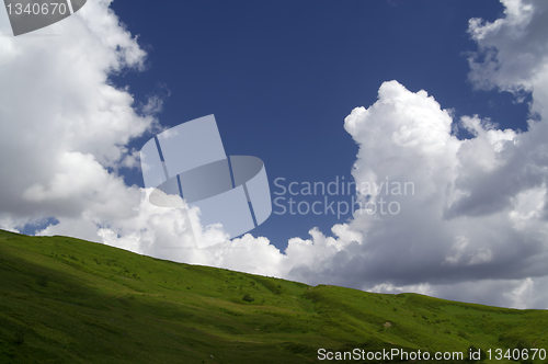 Image of Green grass and blue sky with clouds