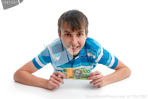 Image of Happy smiling boy holding money