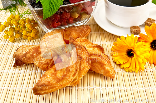 Image of Bun with berries, flowers and coffee