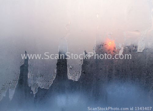 Image of ice and sun on winter windowpane 