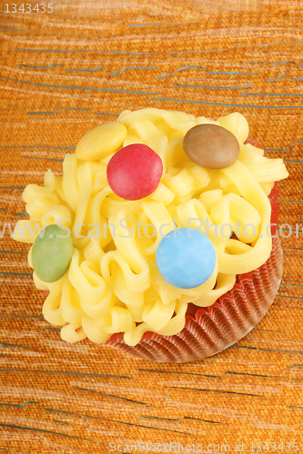 Image of Fancy yellow cupcake with confectionery