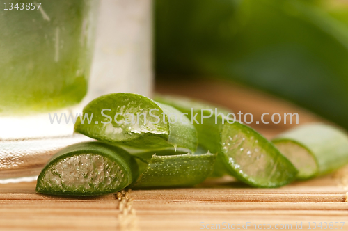 Image of aloe vera juice with fresh leaves