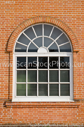 Image of White painted wood arched window