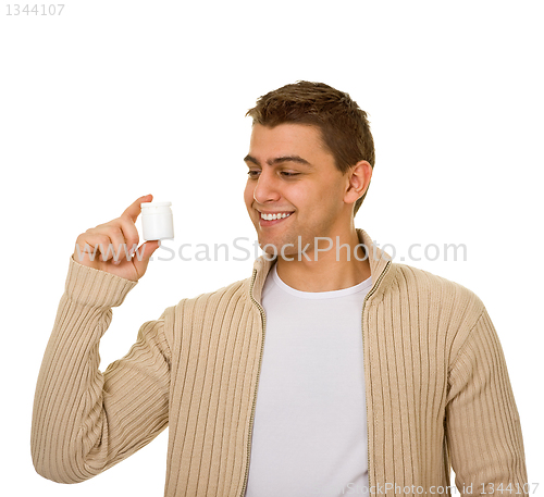 Image of man holding a bottle of medicine