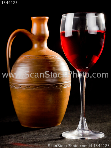 Image of Pitcher and a glass of red liquid 