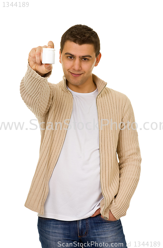 Image of man holding a bottle of medicine