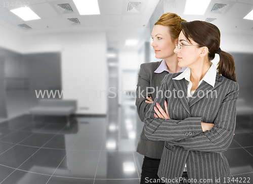 Image of portrait of two women in office clothes 