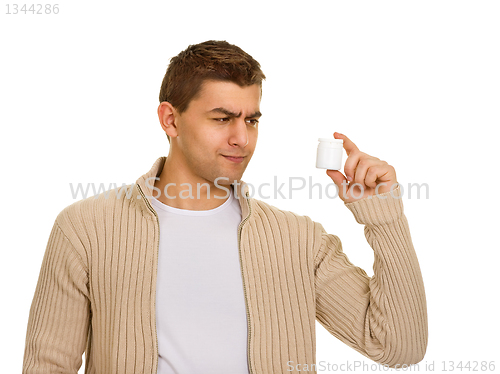 Image of man holding a bottle of medicine