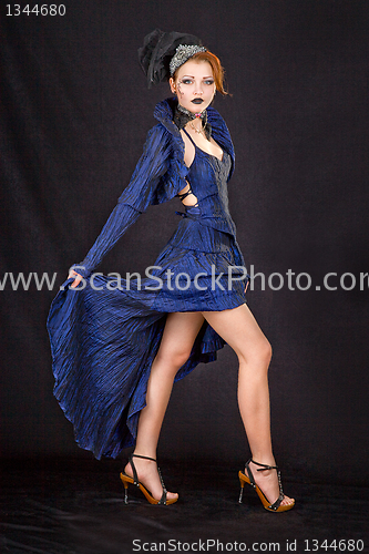 Image of girl in a blue dress on a black background