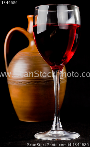 Image of Pitcher and a glass of red liquid 