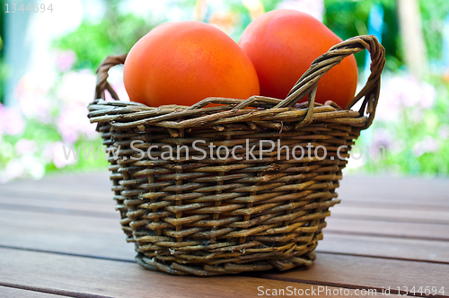 Image of straw basket full of  tomatoes