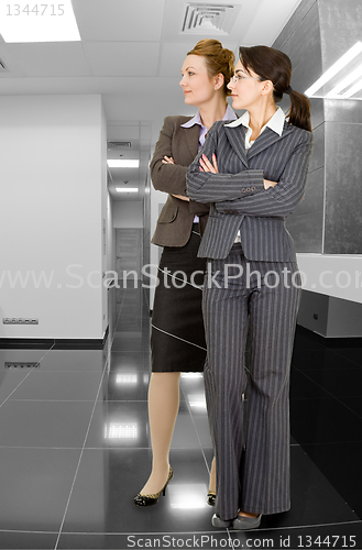 Image of portrait of two women in office clothes 