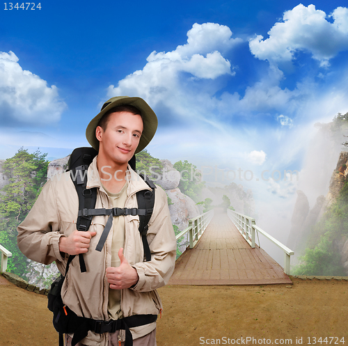 Image of young  tourist on wooden bridge 