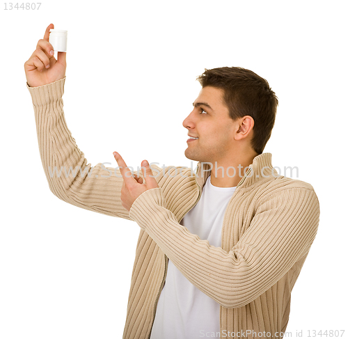 Image of man holding a bottle of medicine