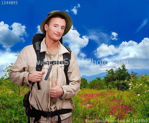 Image of young man dressed in a tourist 