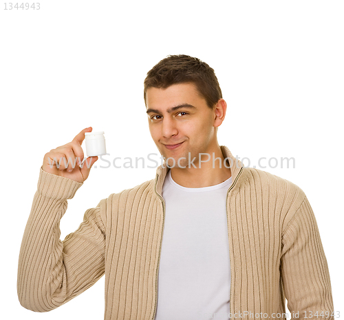 Image of man holding a bottle of medicine