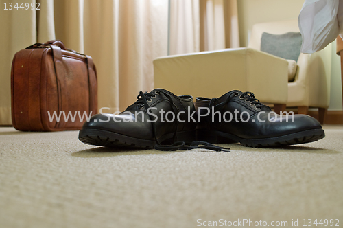 Image of men's shoes and suitcase