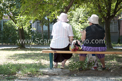 Image of Two elderly womens seated on a bench