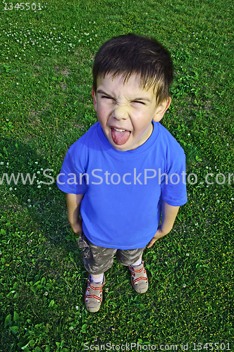 Image of Young boy tongue sticking