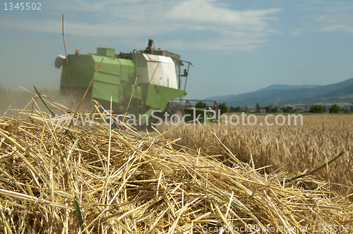 Image of Tractor and combine harvesting